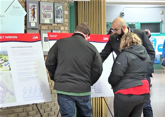 people looking at project information boards
