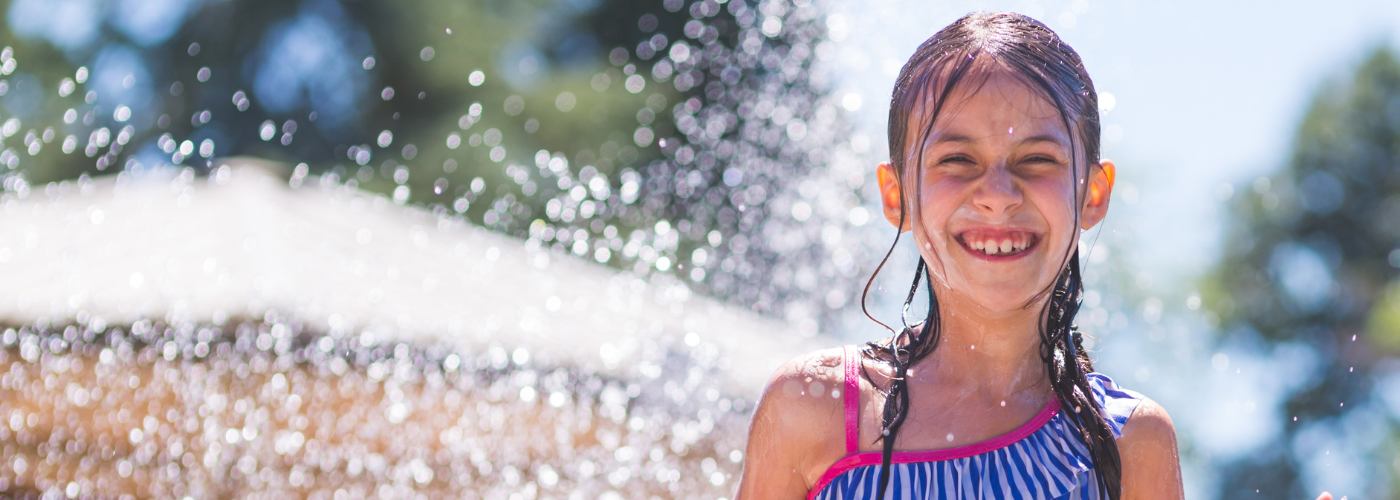 Girl playing at splash pad