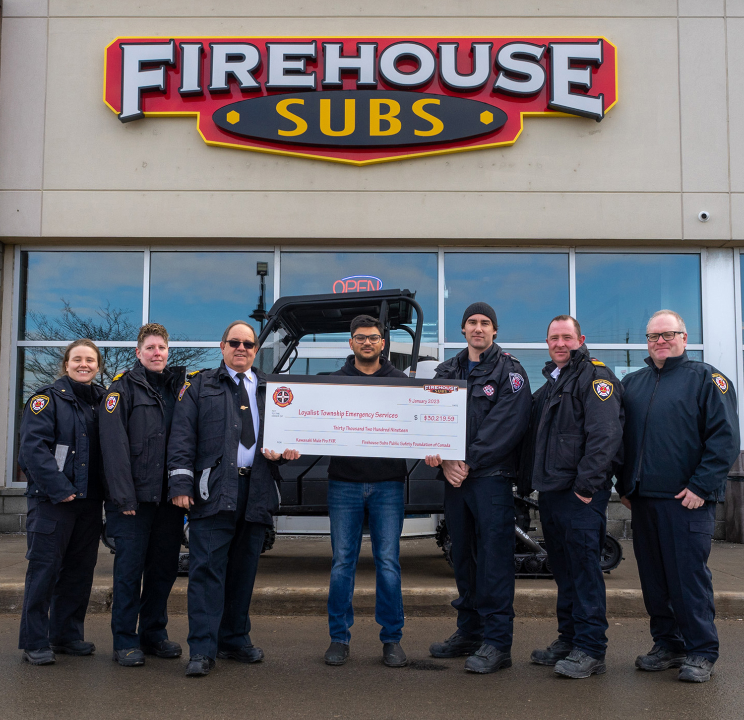 Loyalist Firefighters recieving cheque from firehouse subs