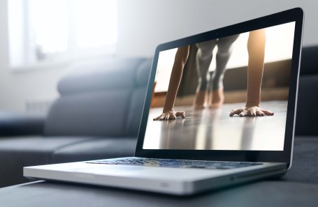 woman doing a plank on a computer screen
