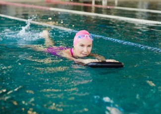 Adult using flutter board in pool