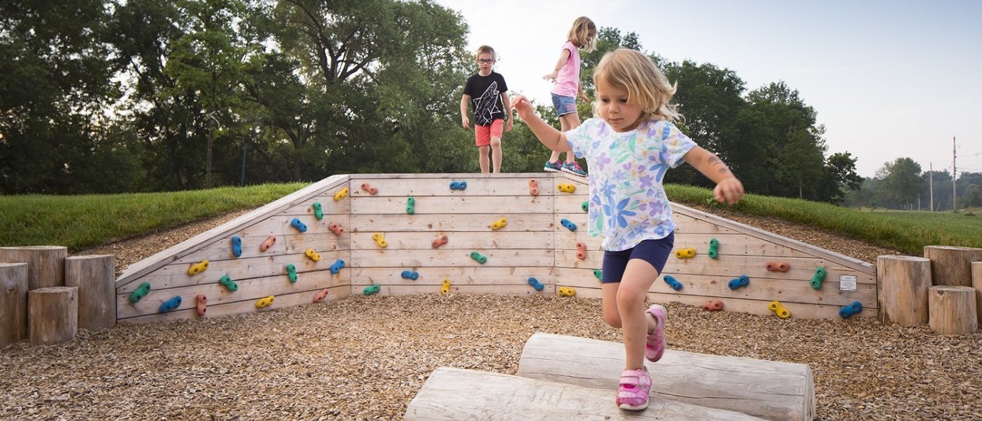 kids playing on natural playground