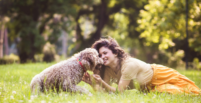 Women on grass with dog