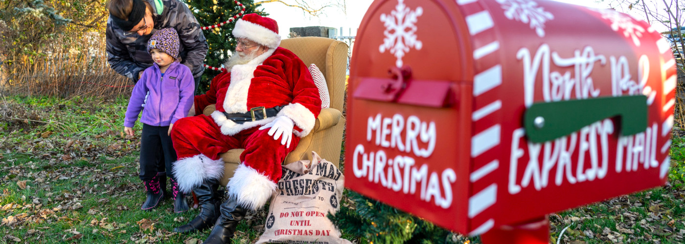 child being presented to Santa