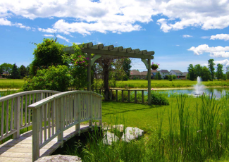 Bridge to pergola and fountain in lake