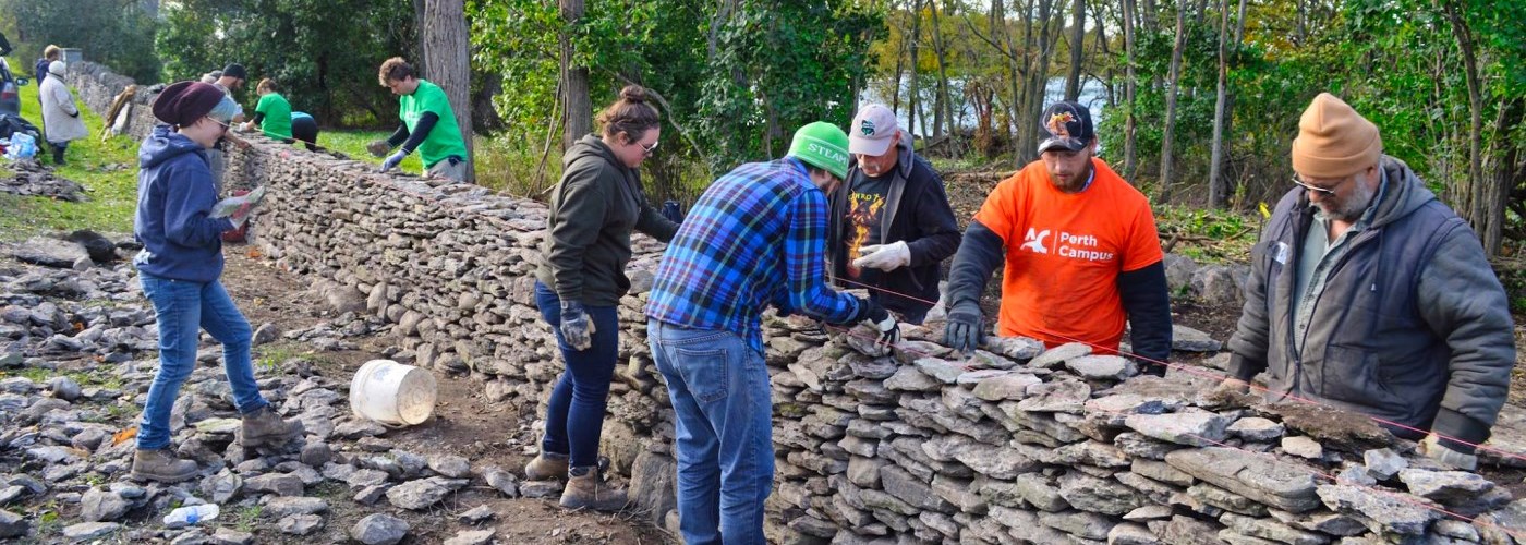 people working on a dry stone wall