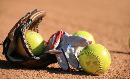 softball glove lying on softball diamond