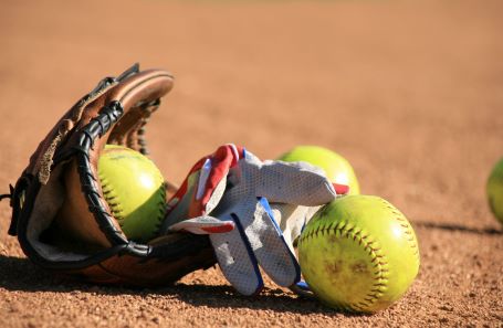 softball glove lying on softball diamond