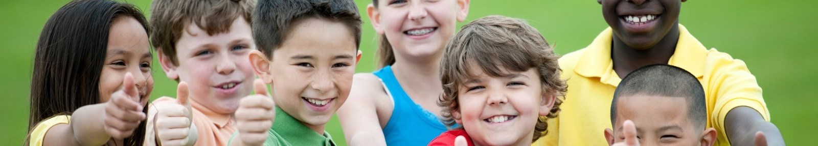 line of children with thumbs up