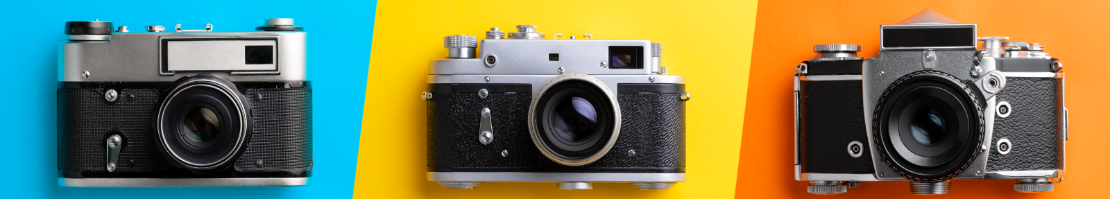 three cameras lined up on coloured background