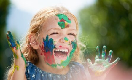 smiling little girl with face painted