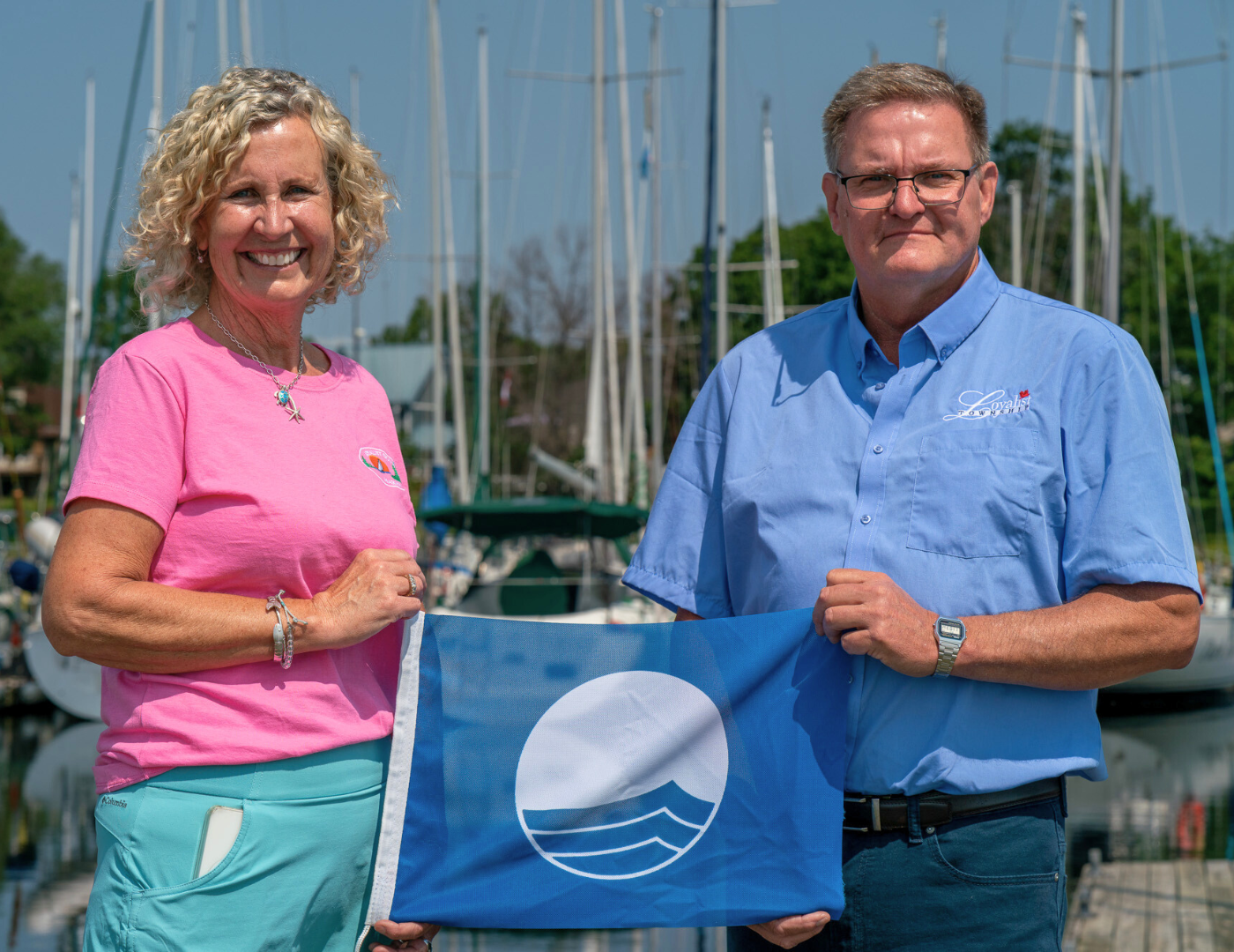 Mayor Hegadorn celebrating Loyalist Cove Marina' Blue Flag designation.