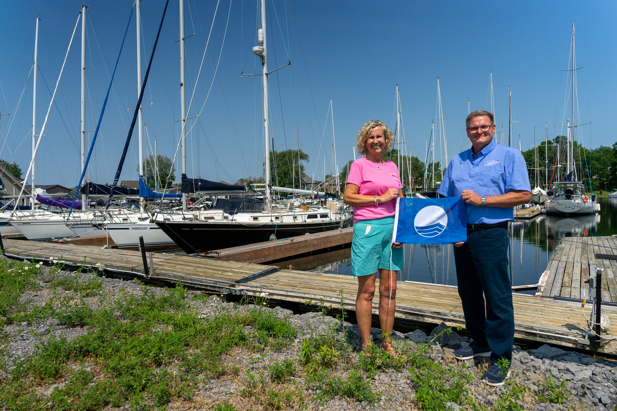 Mayor Hegadorn celebrating Loyalist Cove Marina' Blue Flag designation.