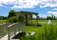 Bridge to pergola and fountain in lake