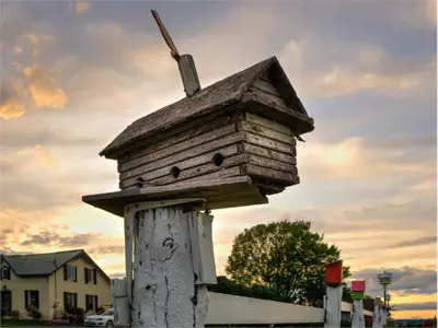 Birdhouse on fence post