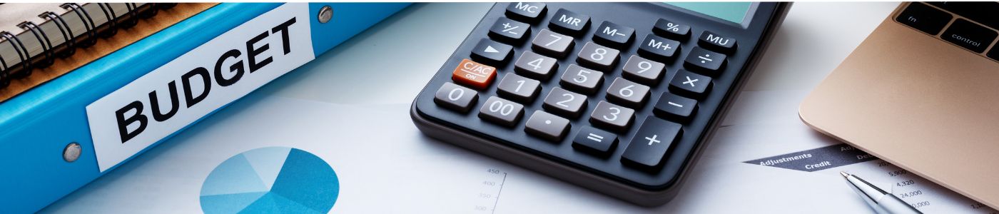 Budget Header Desk with a binder, calculator and papers