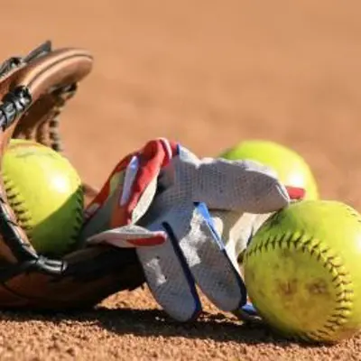 softball glove lying on softball diamond