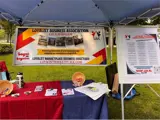 Loyalist Business Association banner behind a table with pamphlets.