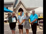 Photo of two residents and Deputy Mayor Townend and Mayor Hegadorn at the 75 Annual Garden Party.