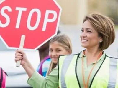 crossing guard holding stop sign