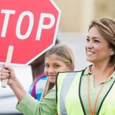 crossing guard holding stop sign