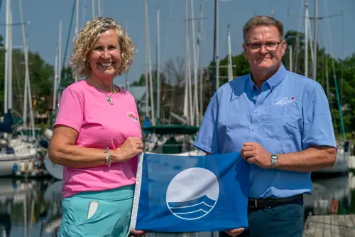 Mayor Hegadorn celebrating Loyalist Cove Marina' Blue Flag designation.