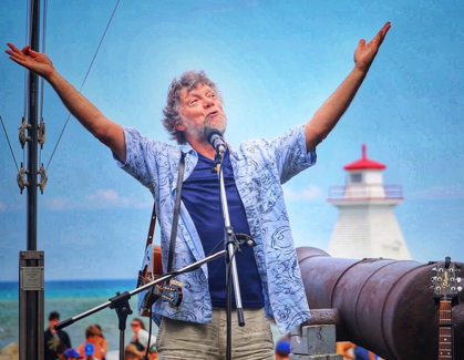 man in blue shirt singing