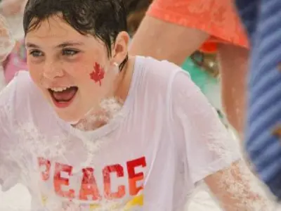 smiling boy covered in foam