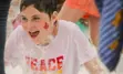 smiling boy covered in foam