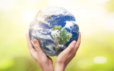 A pair of hands holding planet Earth.