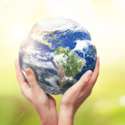A pair of hands holding planet Earth.