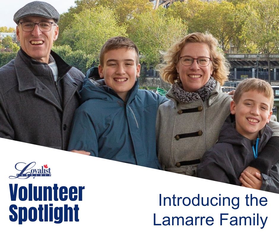 a smiling family of four in jackets