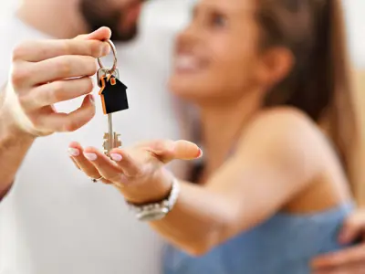 Couple holding keys to home