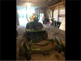 John Deere Lawn Mower, zero turn in a garage.
