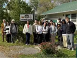 Students with Amherst Island residents standing in front of The Back Kitchen cafe.