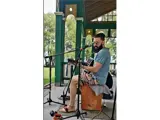 A man sitting down on a wooden box playing guitar.
